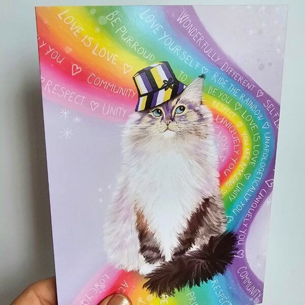 Cute LGBTQ love is love greeting card featuring a fluffy ragdoll cat sitting on a rainbow wearing a bucket hat with non binary colours.