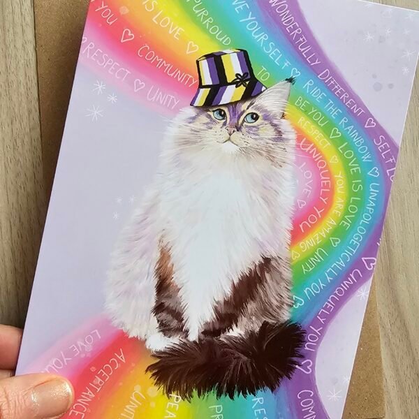 Cute LGBTQ love is love greeting card featuring a fluffy ragdoll cat sitting on a rainbow wearing a bucket hat with non binary colours.