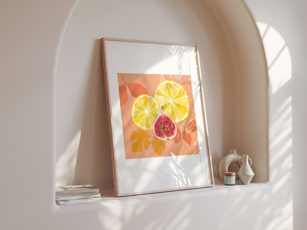 Framed print showing a still life art print of lemons and a fig.