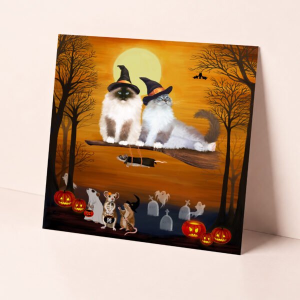 Ragdoll cat themed halloween card featuring two fluffy kitties riding a witch's broom in a spooky forest at sunset.