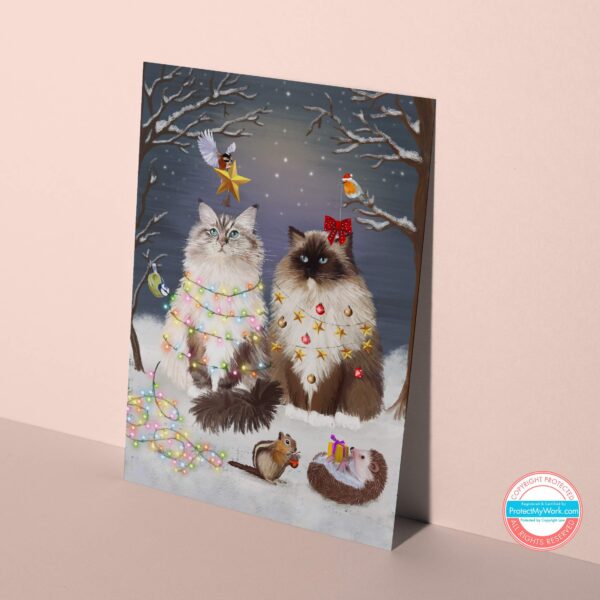 Magical ragdoll cat christmas card showing fluffy cats in a winter forest