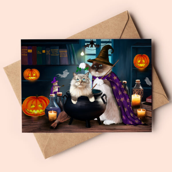 Cute halloween card featuring a ragdoll cat sitting in a cauldron and another one wearing a witch's hat and cape.