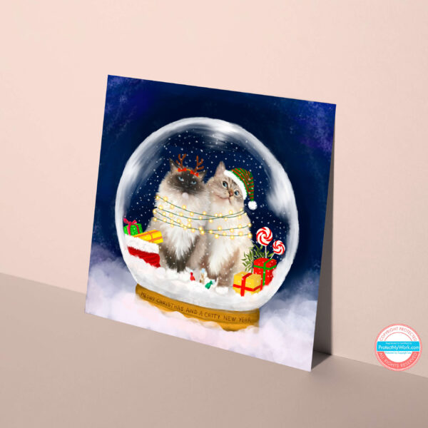 Ragdoll Cat Christmas Card showing two fluffy cats in a magical snow globe.