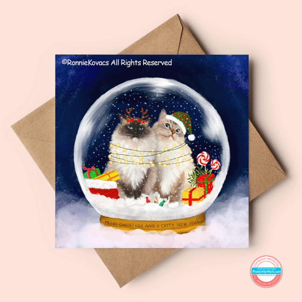 Cute ragdoll christmas card showing fluffy cats in a snowglobe.