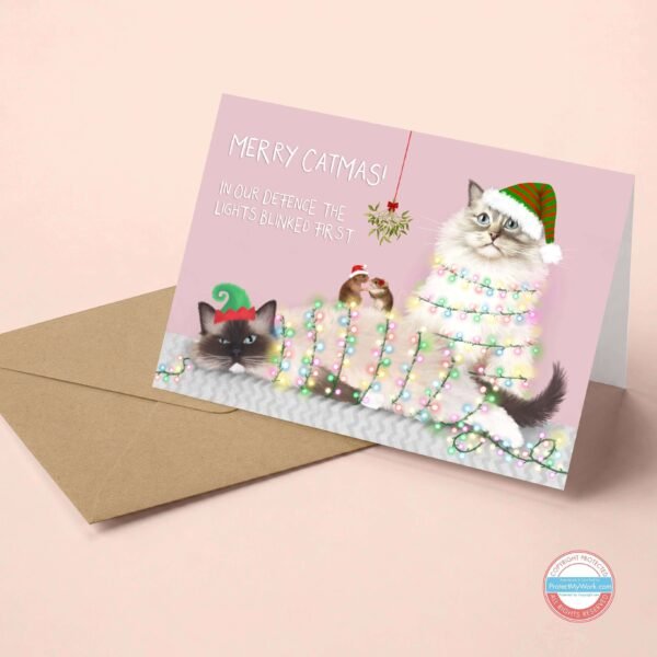 Ragdoll Cat Christmas card featuring two fluffy cat tangled in fairy lights.