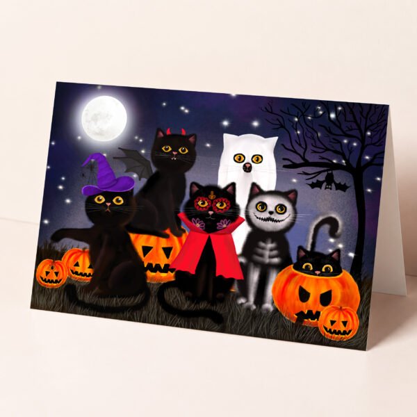Halloween greeting card featuring black cats dressed in spooky costumes for trick or treating.