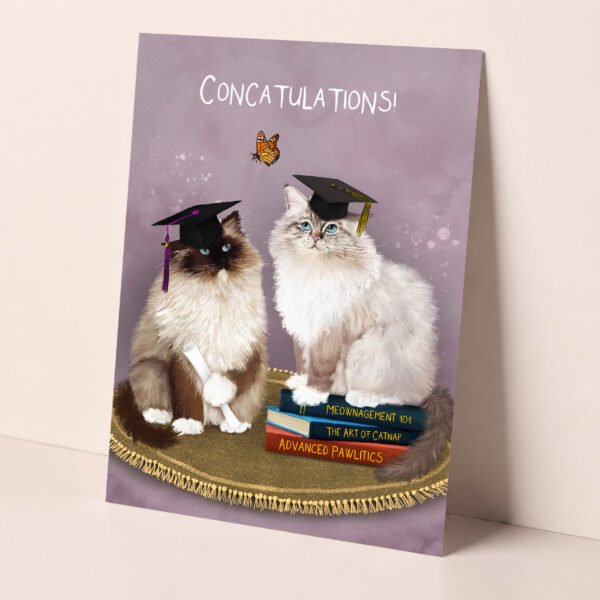 Ragdoll cat congratulations card for graduation showing two fluffy cat holding their diplomas wearing graduation caps.